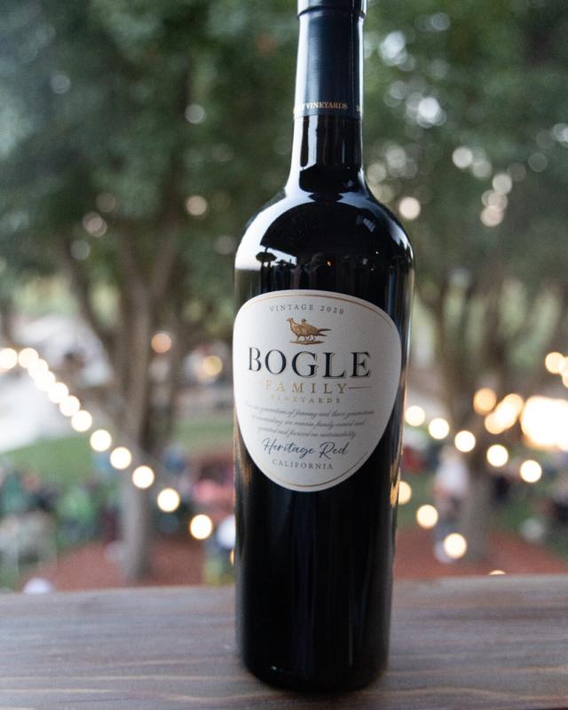 Bottle of Bogle wine on table with lit up trees in background
